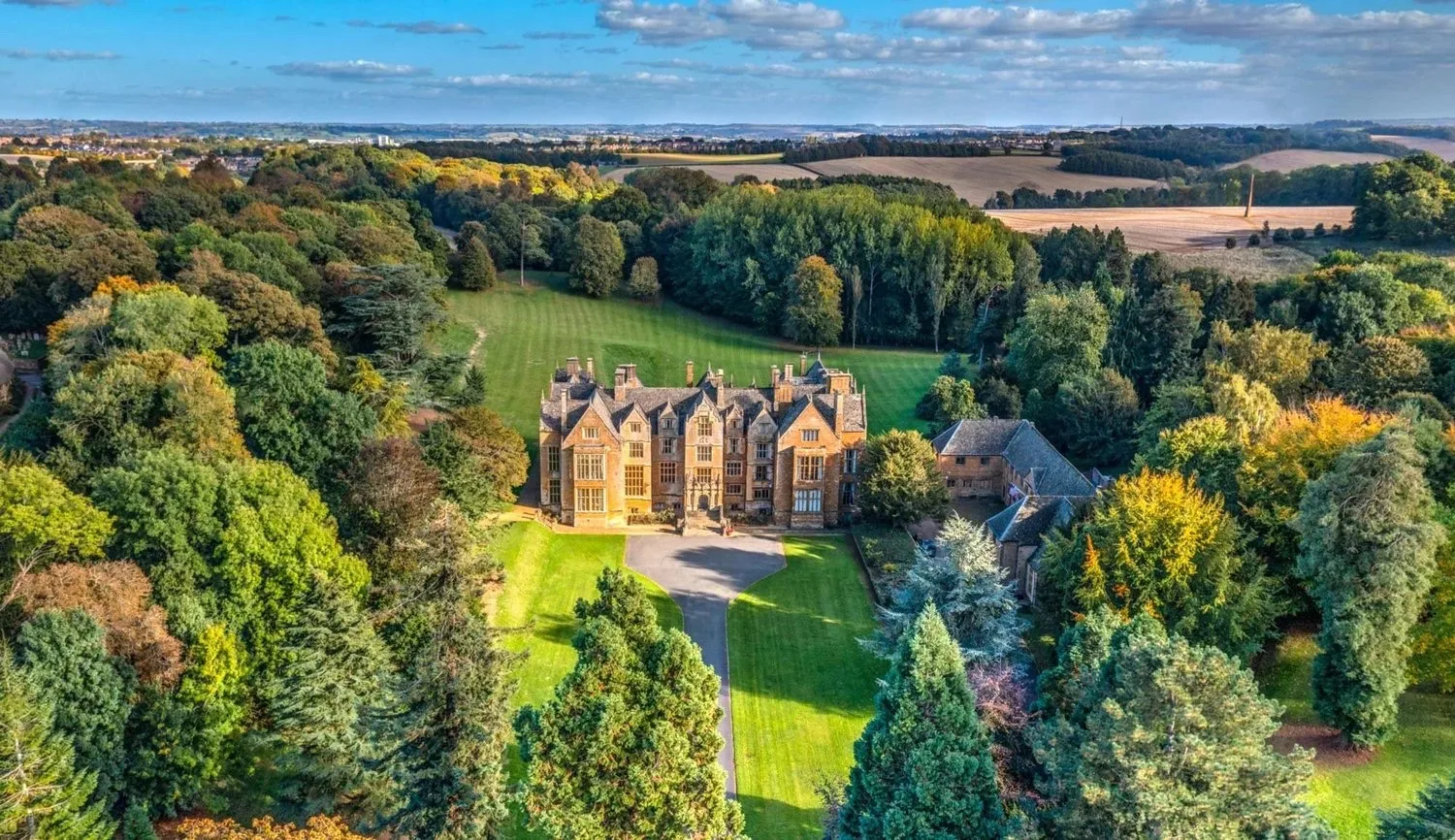Aerial view of the Wroxton Abbey estate and its grounds in autumn