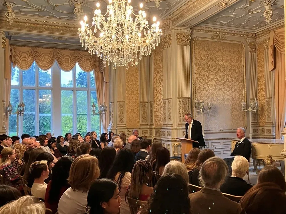 A lecture underway in the Regency Room, beneath its chandelier